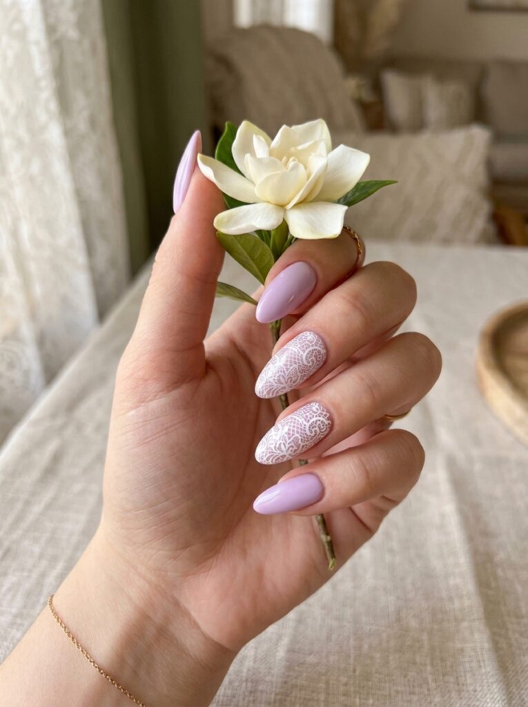Negative space manicure with soft peach polish and tiny daisies.